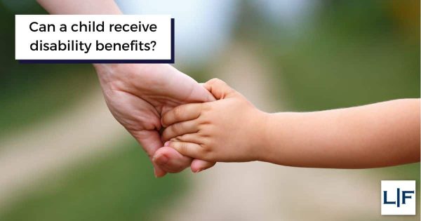 disabled child holding adult hand